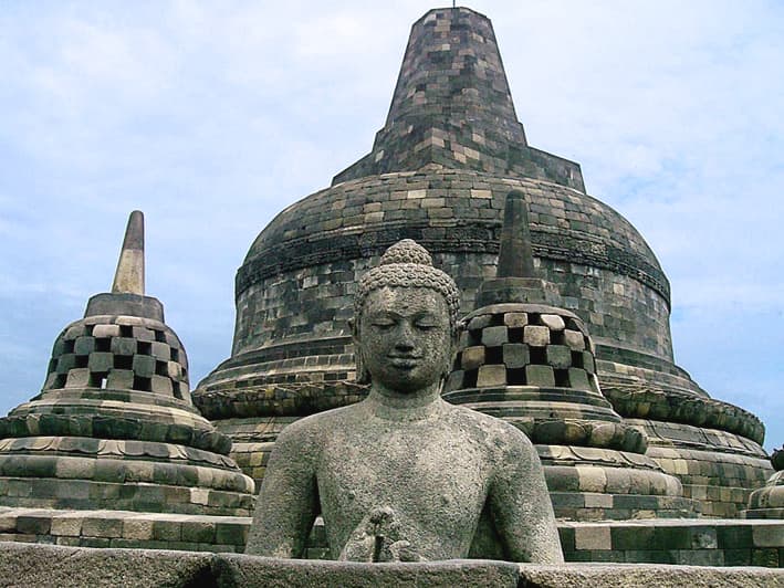 A Buddha seated within a bell-shaped stupa