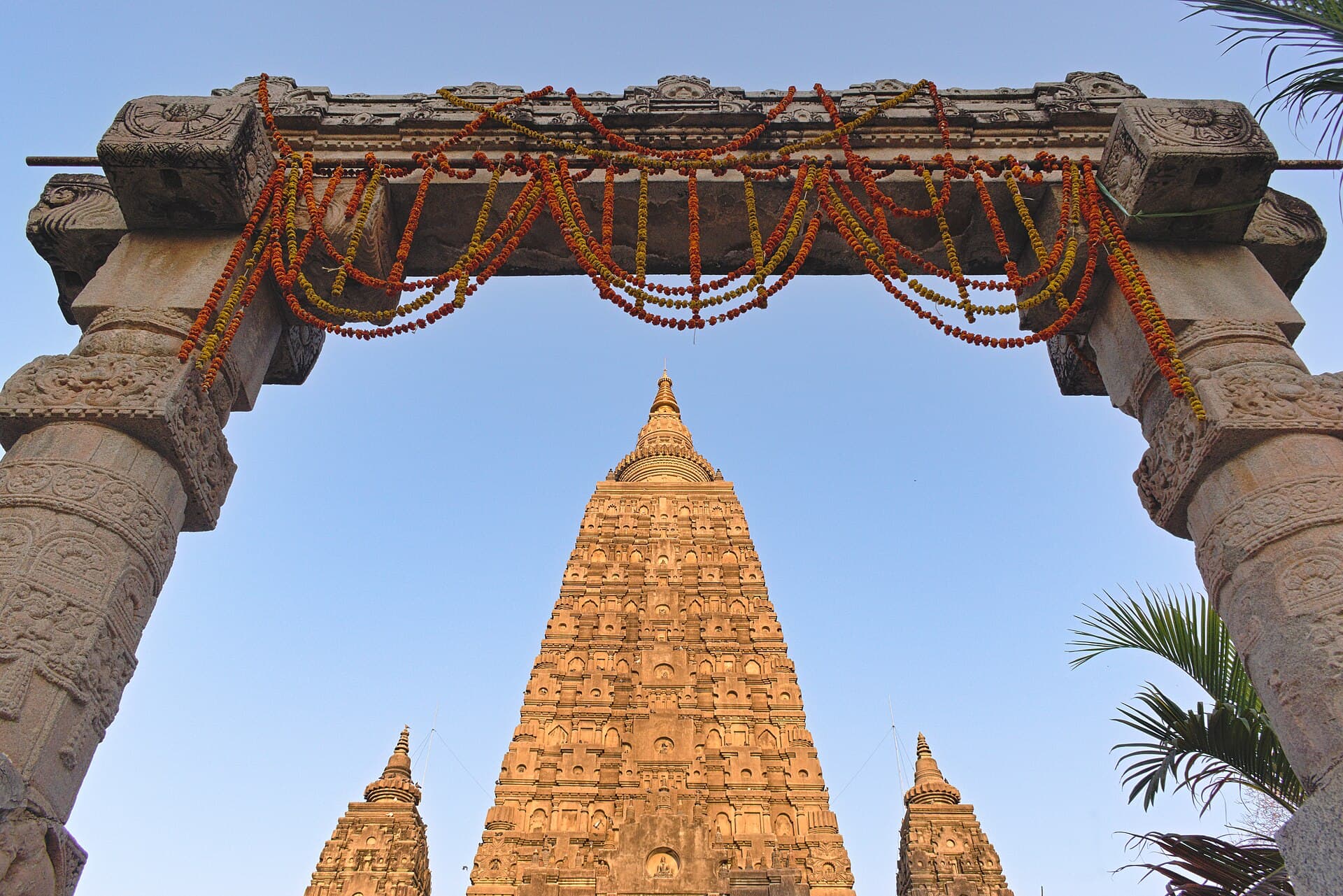 The great tower seen through a gate hung with marigold garlands
