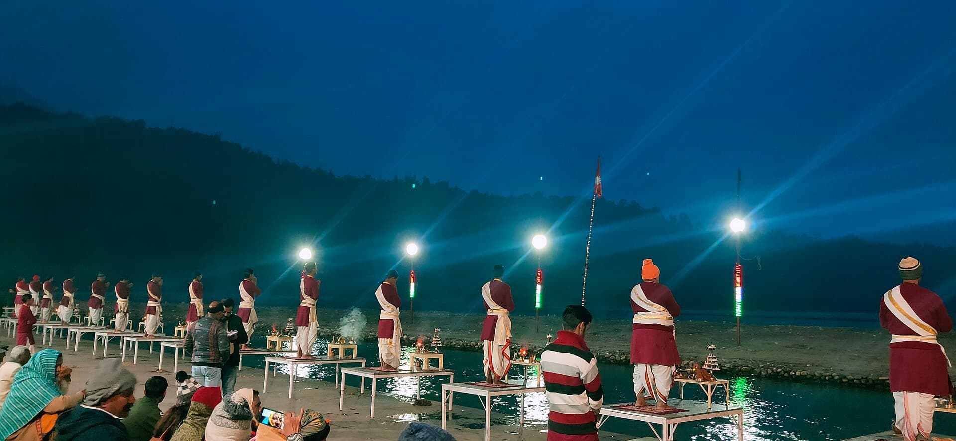 The evening Ganga Aarti — priests raising lamps in rows along the river steps