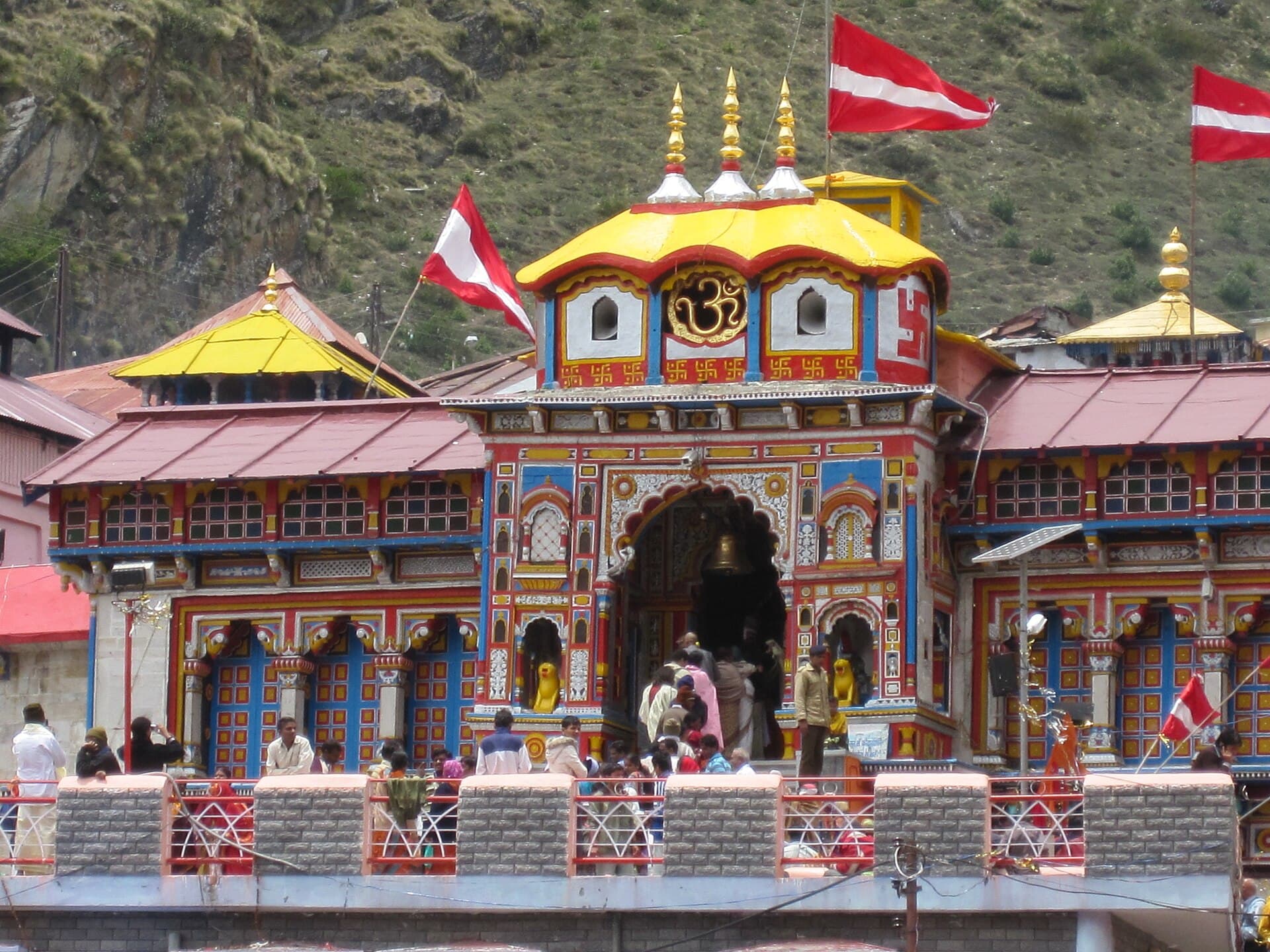 The brightly painted façade of Badrinath temple against the snow peaks
