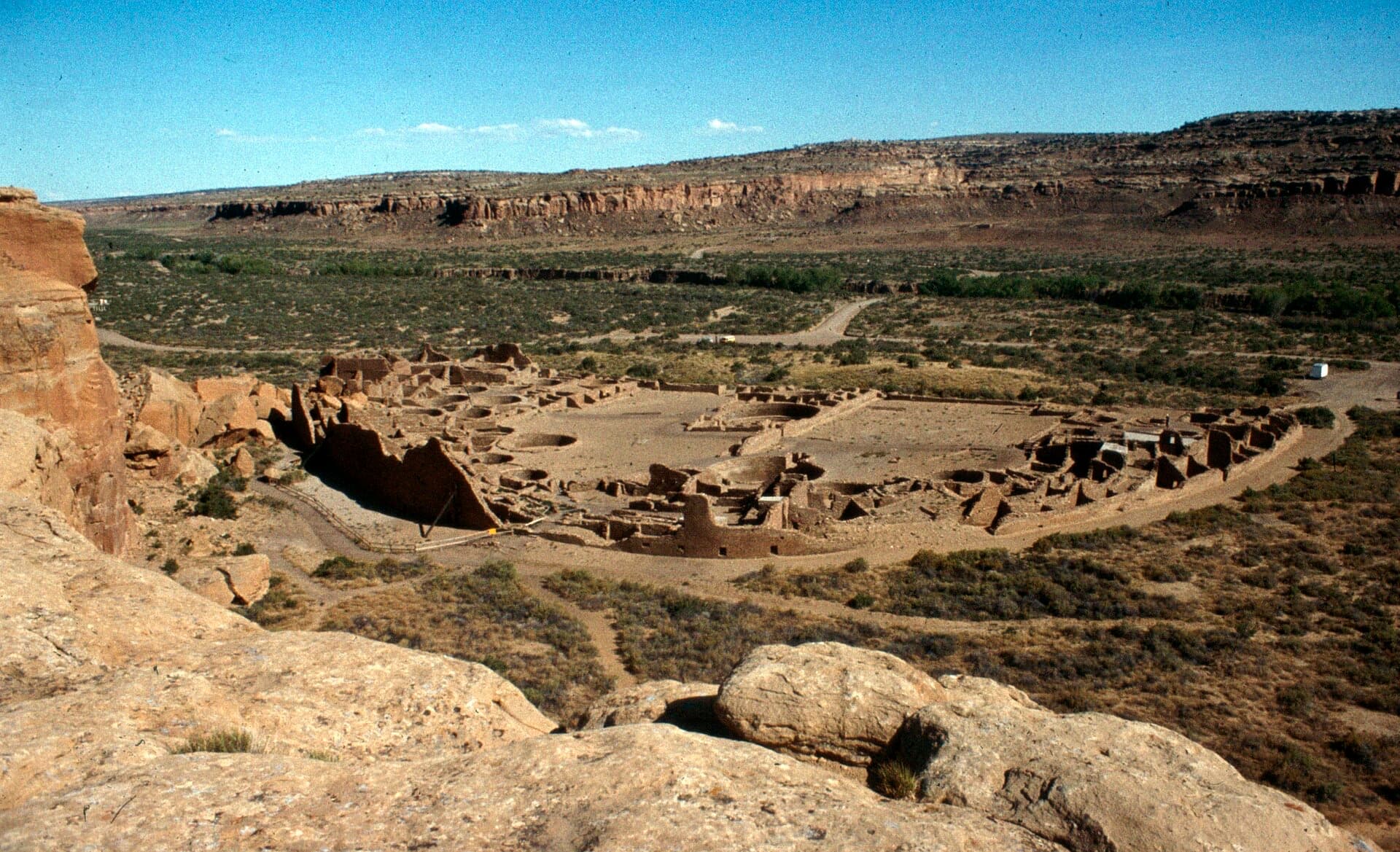 The half-moon great house of Pueblo Bonito seen from the cliff above