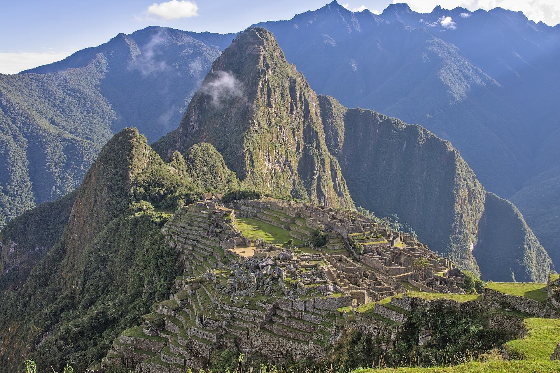 The ruins of Machu Picchu on a cloud-wrapped ridge