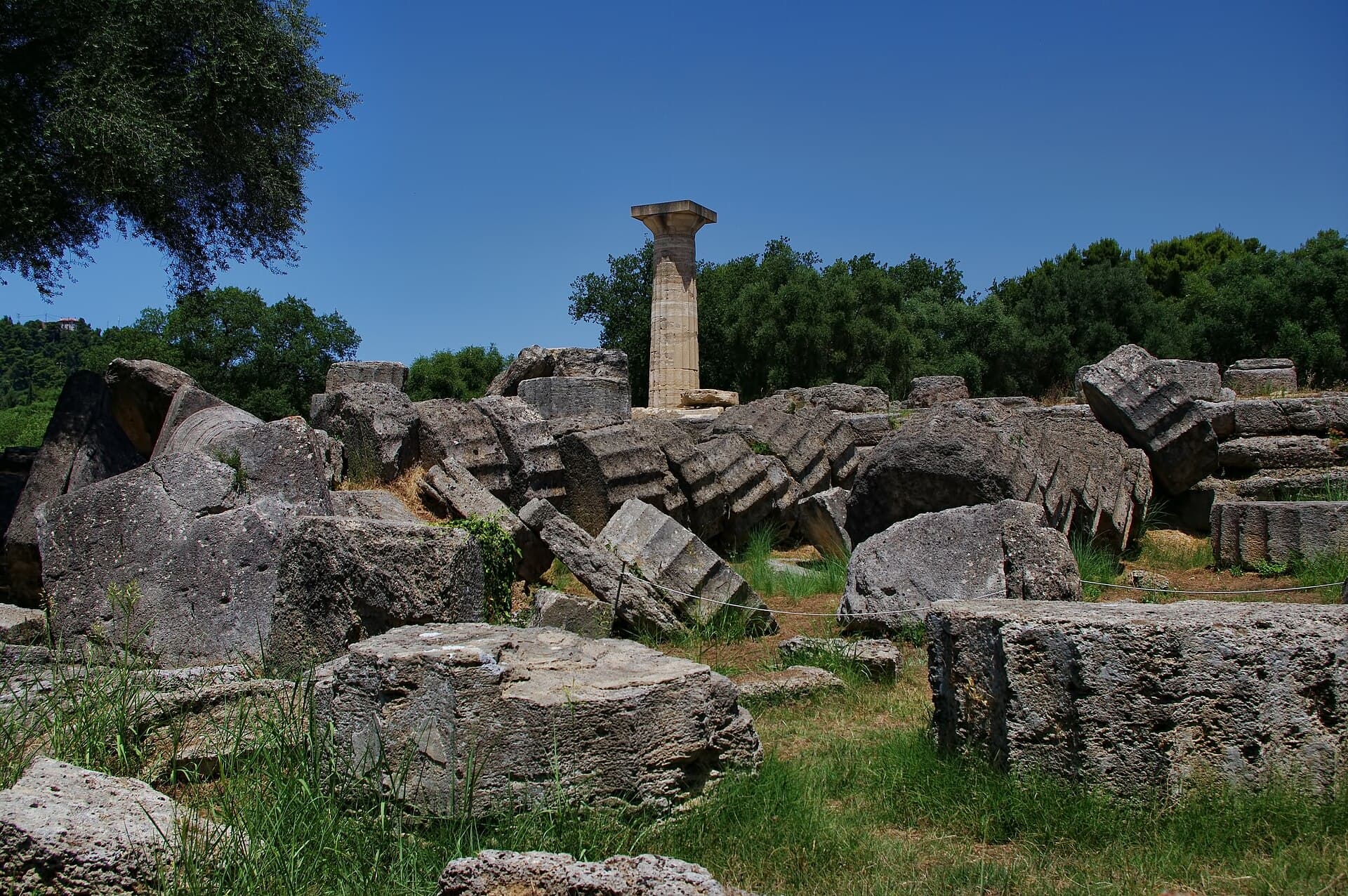 The giant column drums of the Temple of Zeus toppled in a row by earthquake, and one re-raised column