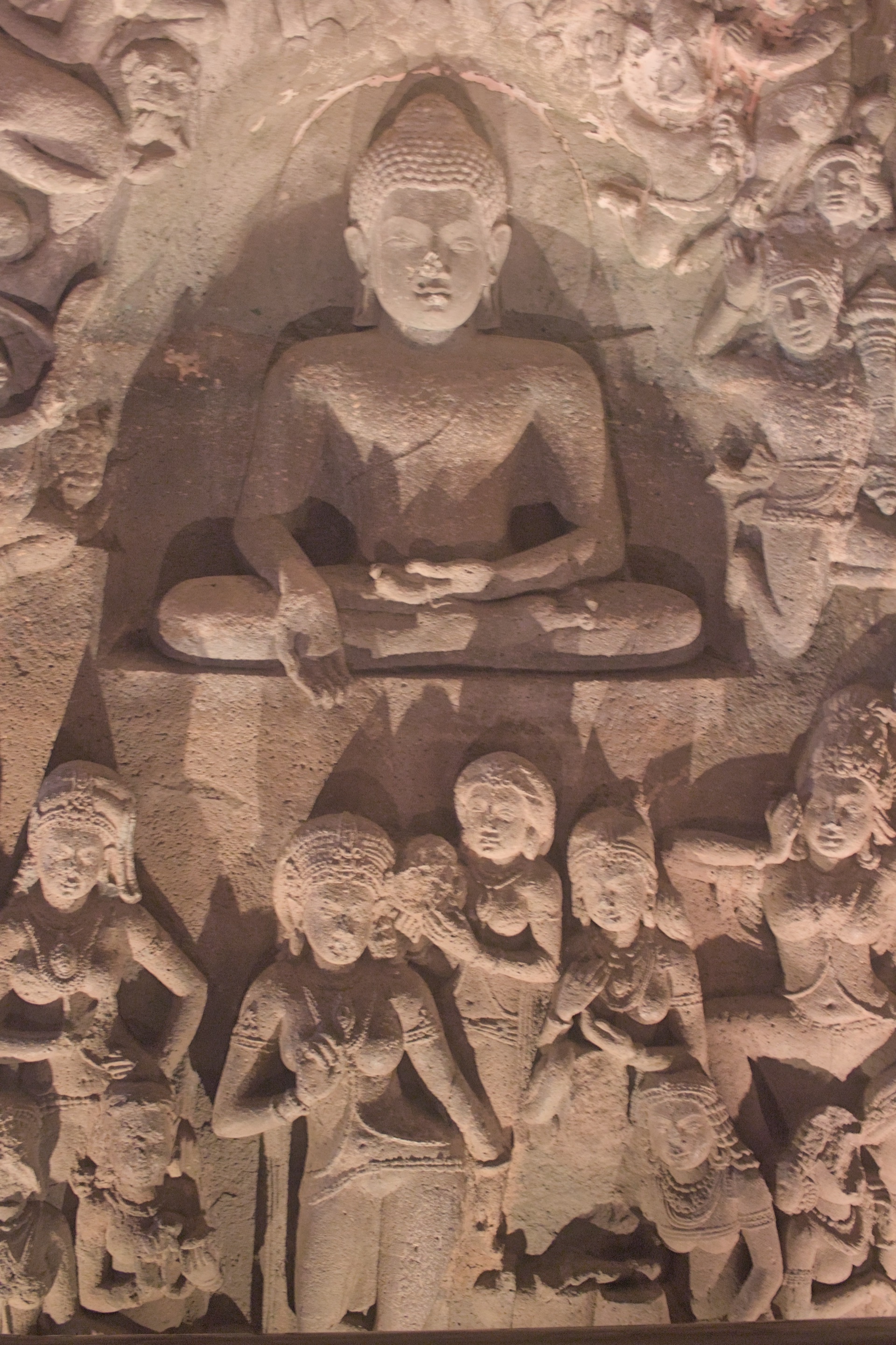 The seated Buddha of Ajanta Cave 26 carved from the living rock, figures around him