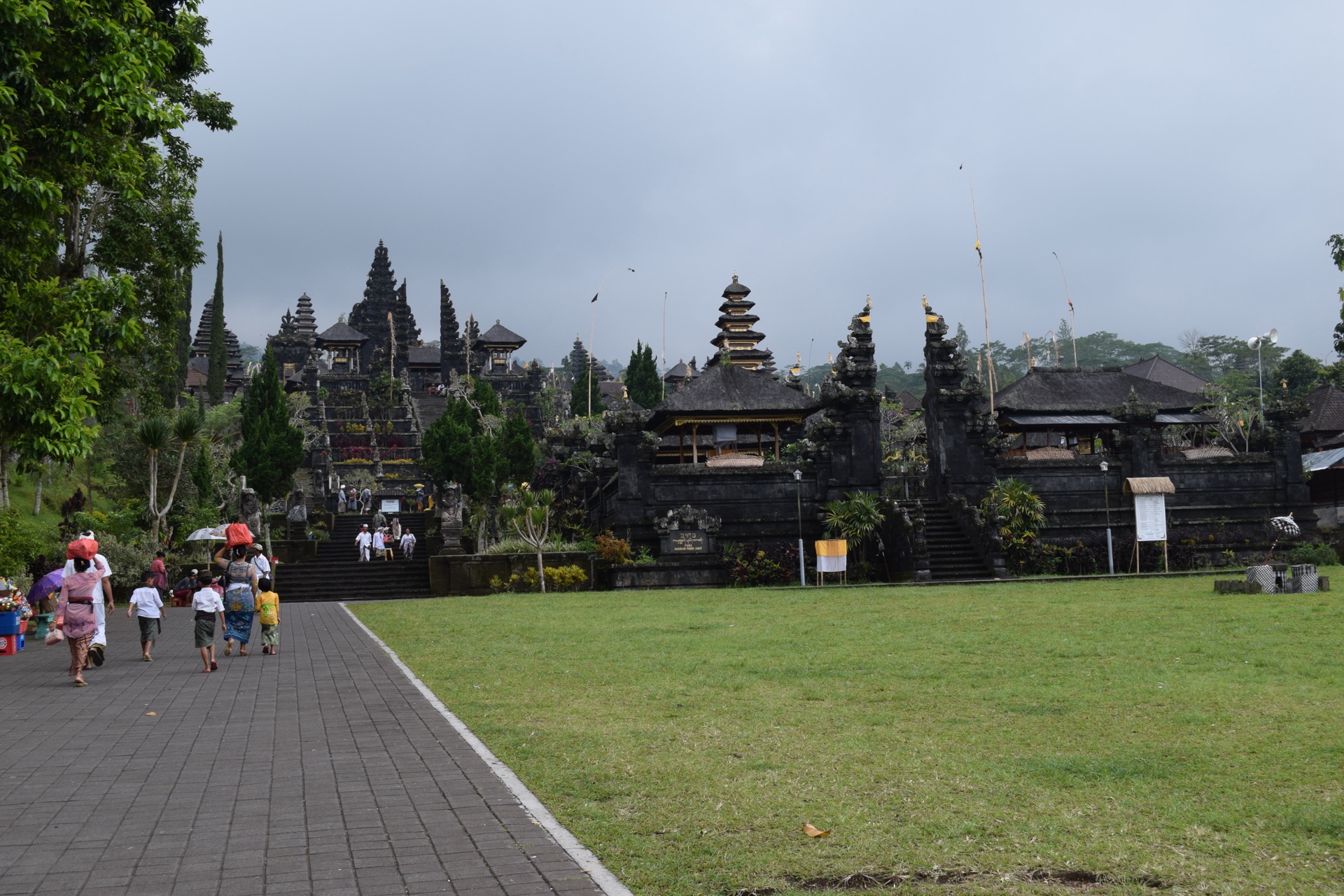 Worshippers in traditional dress climbing toward the split gate and stairway of Besakih