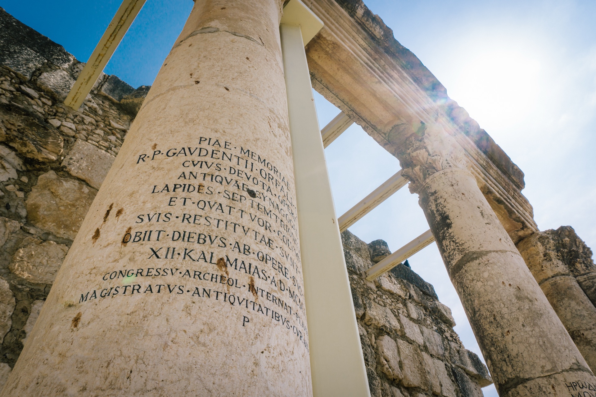 The sunlit white limestone columns of the Capernaum synagogue