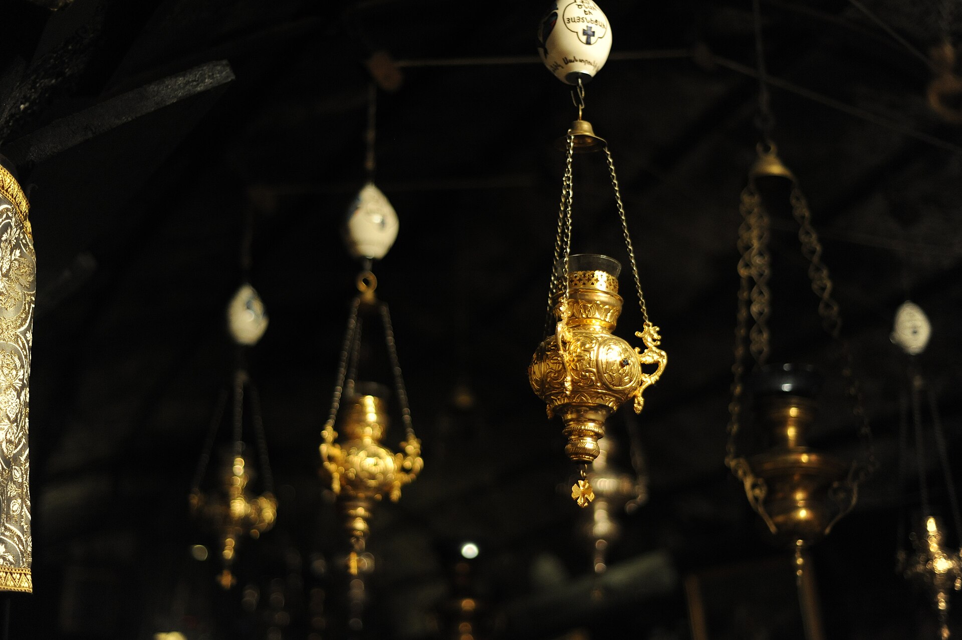 Votive lamps hanging in the Grotto of the Nativity