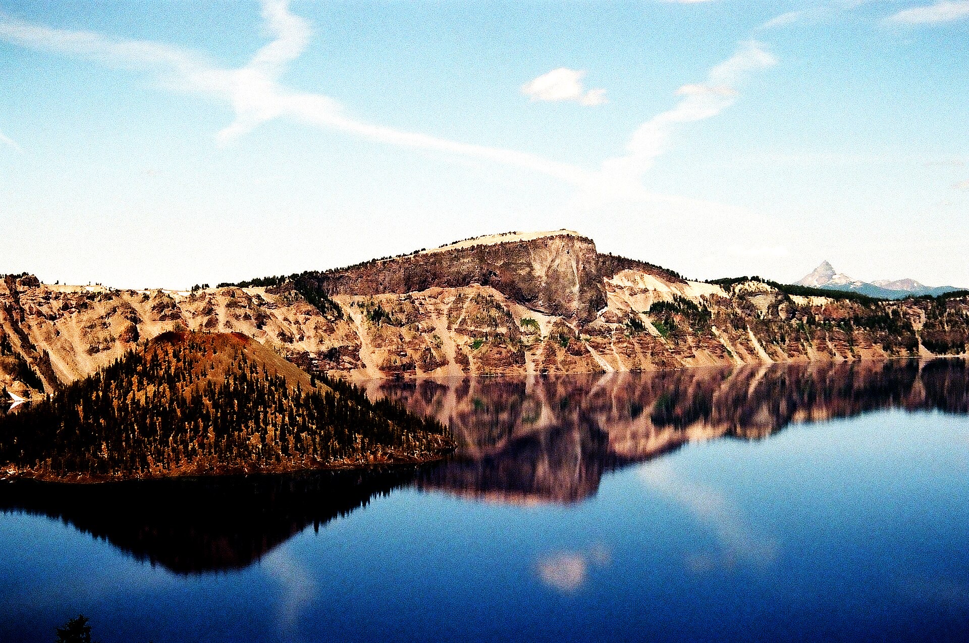 The caldera ridge mirrored on the windless surface of the lake