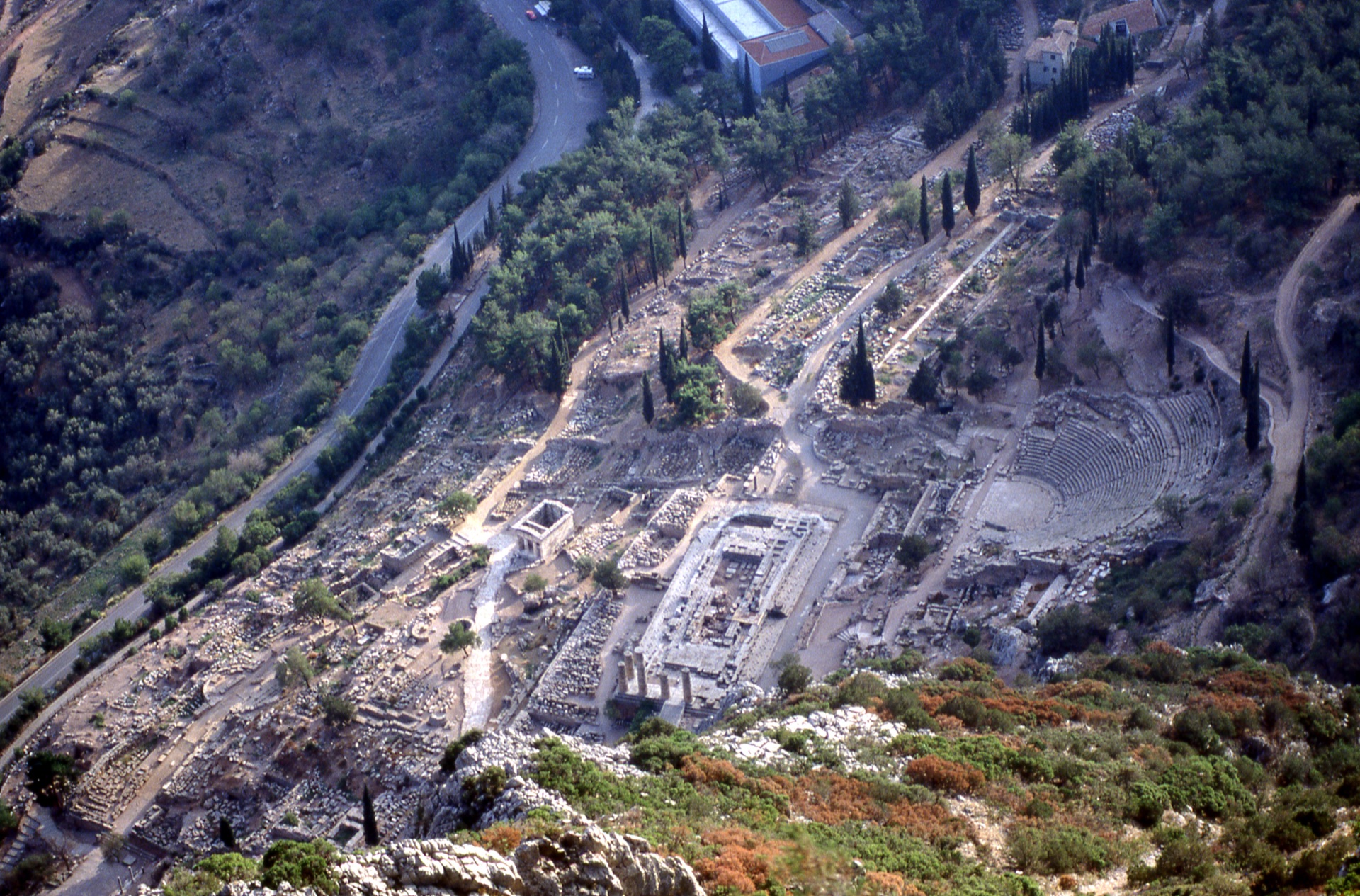 The whole Sanctuary of Apollo seen from the Phaedriades cliffs — temple, theatre and sacred way