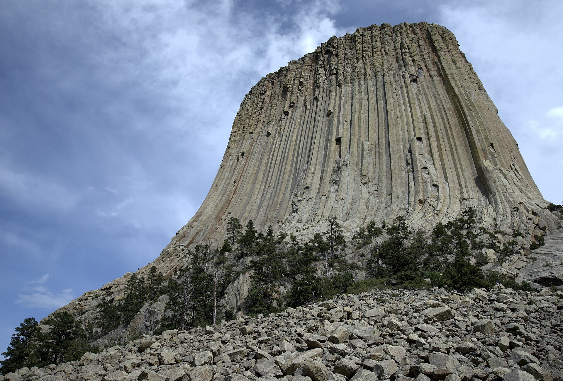 The foot of the tower, hundreds of vertical stone columns rising above a talus slope