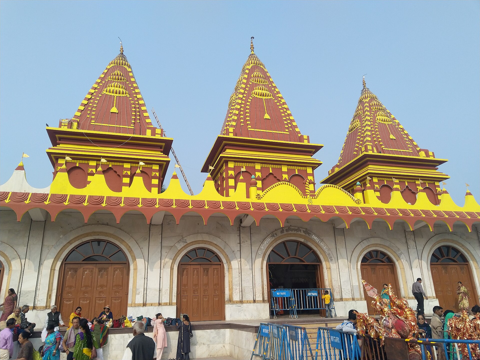 The yellow and red towers of the Kapil Muni temple