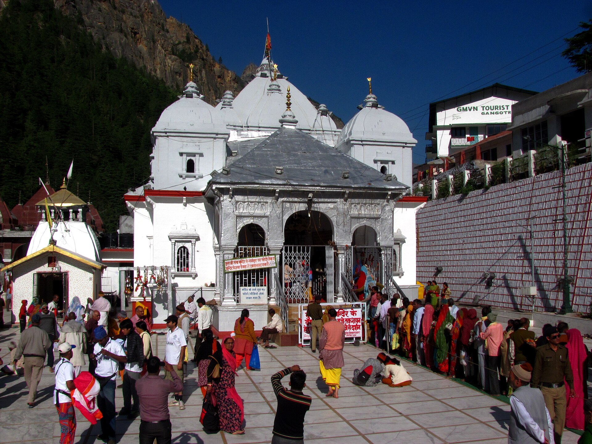 The white temple of the goddess Ganga and pilgrims gathered in the marble courtyard