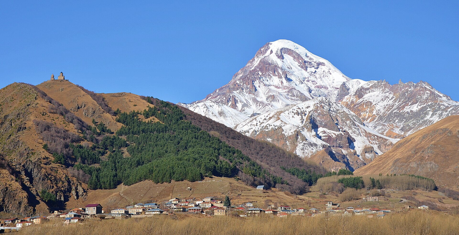 Gergeti Trinity Church on its ridge against the snows of Mount Kazbek