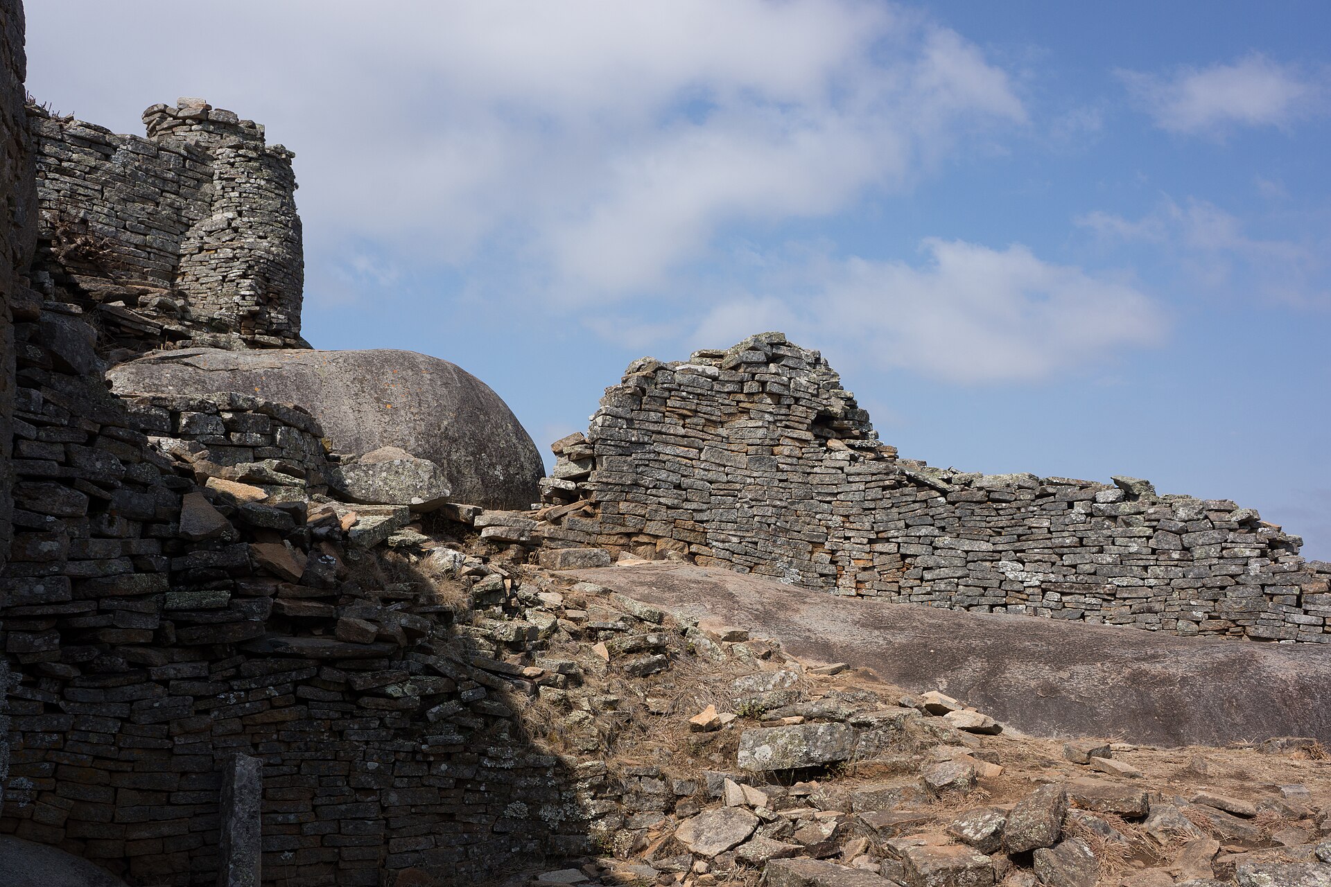 Stone walls merging with the granite boulders of the hill