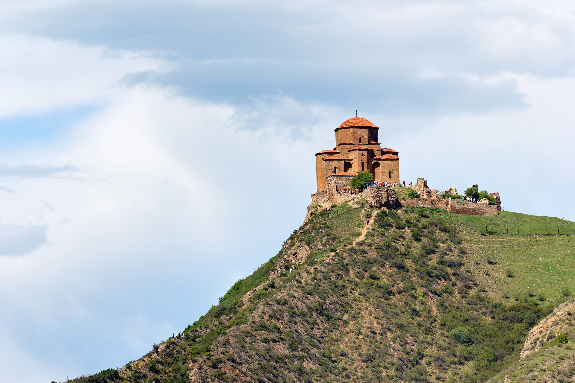 Jvari Monastery standing alone on its hilltop against the clouds