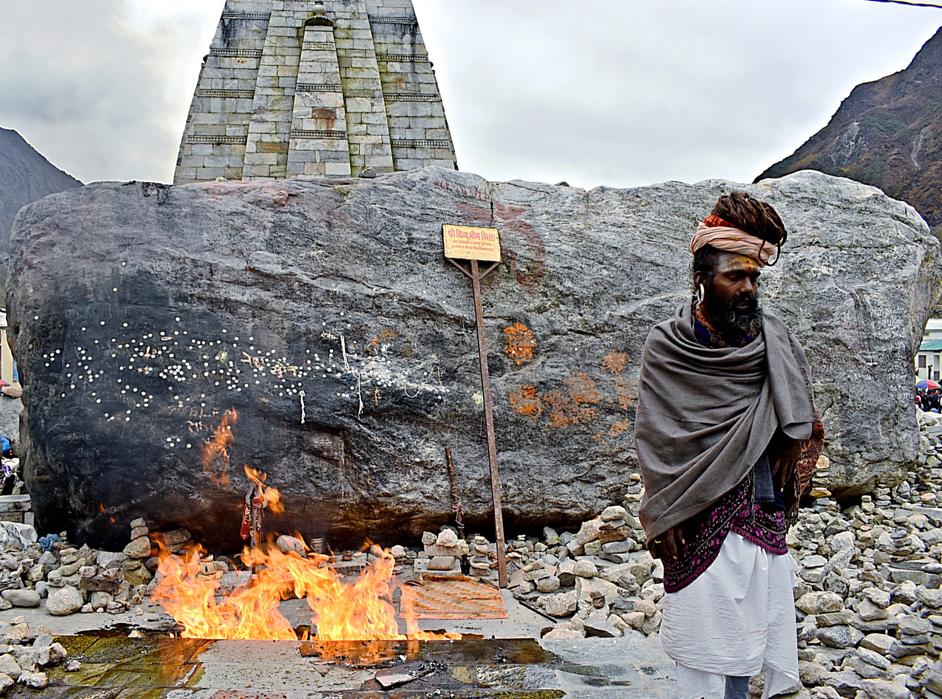 Bhim Shila, the sacred boulder behind the Kedarnath temple, with a sacred fire