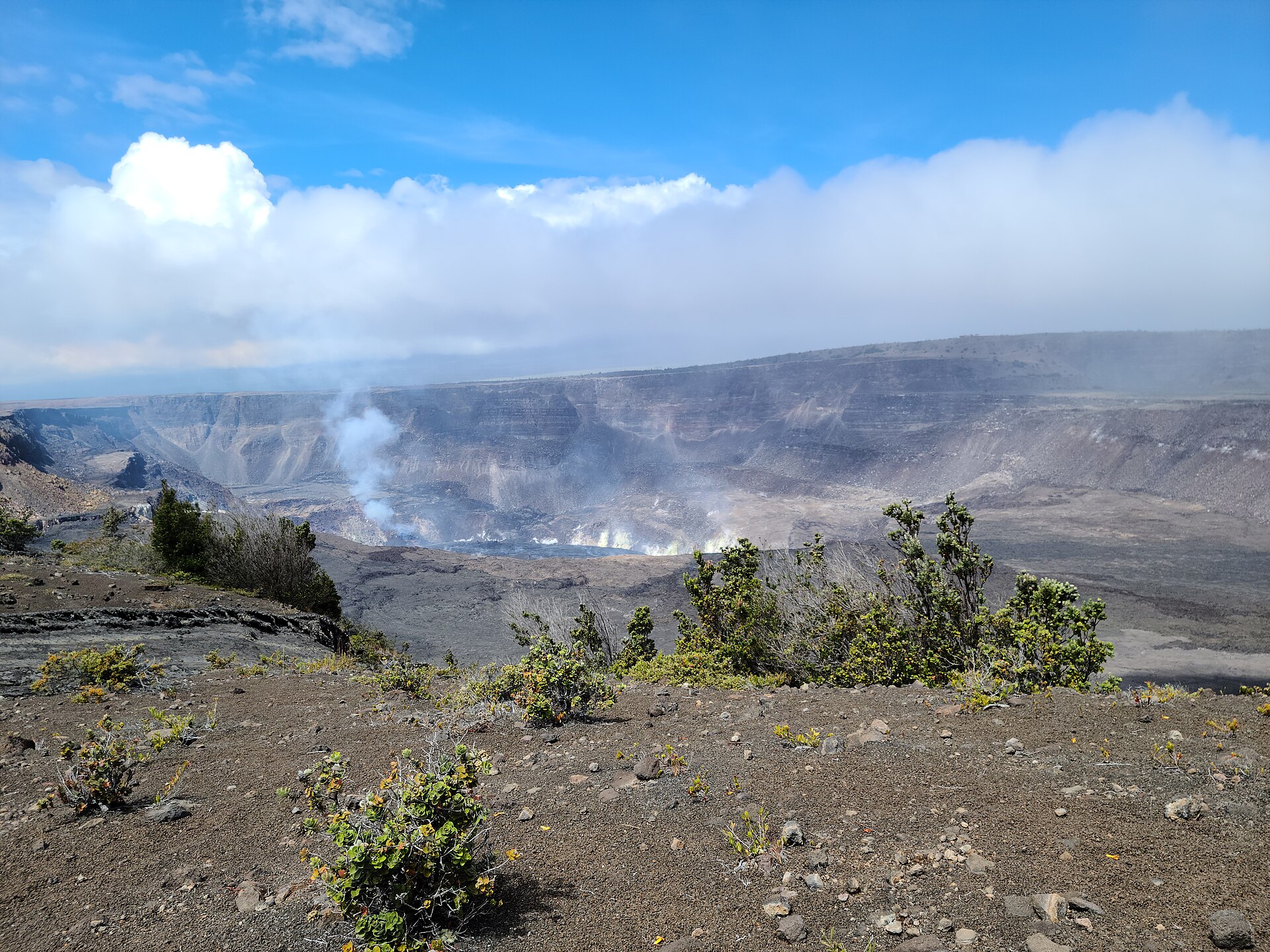 The wide caldera of Kīlauea and Halemaʻumaʻu crater venting steam