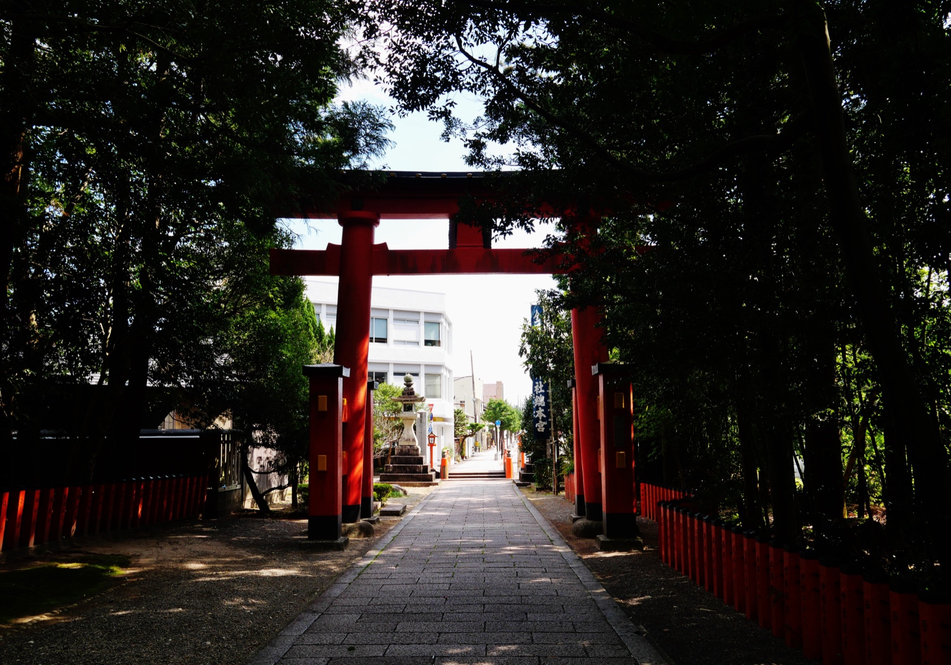 A vermilion torii standing over the stone pilgrim approach