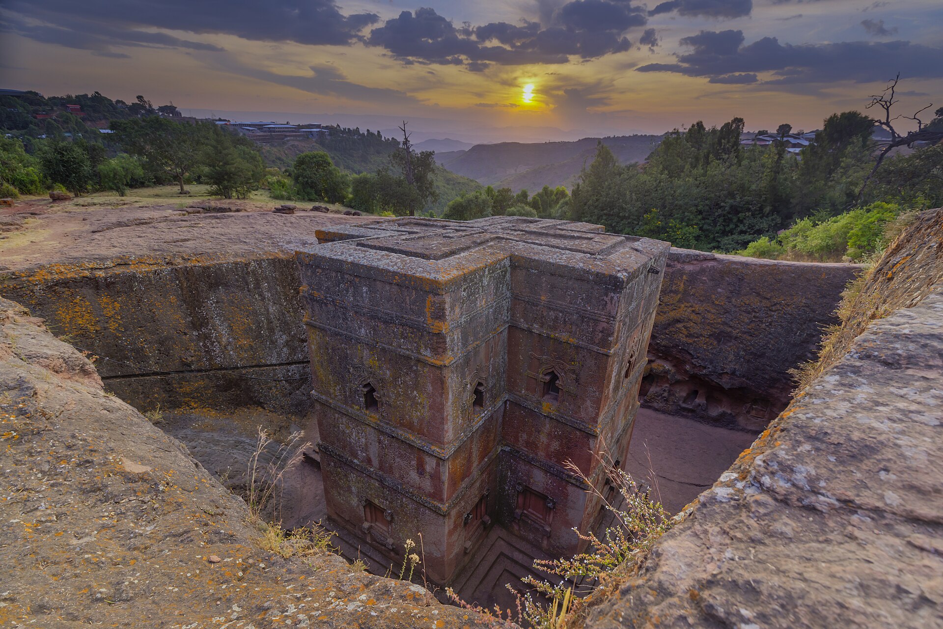 The cross-shaped church bathed in sunset