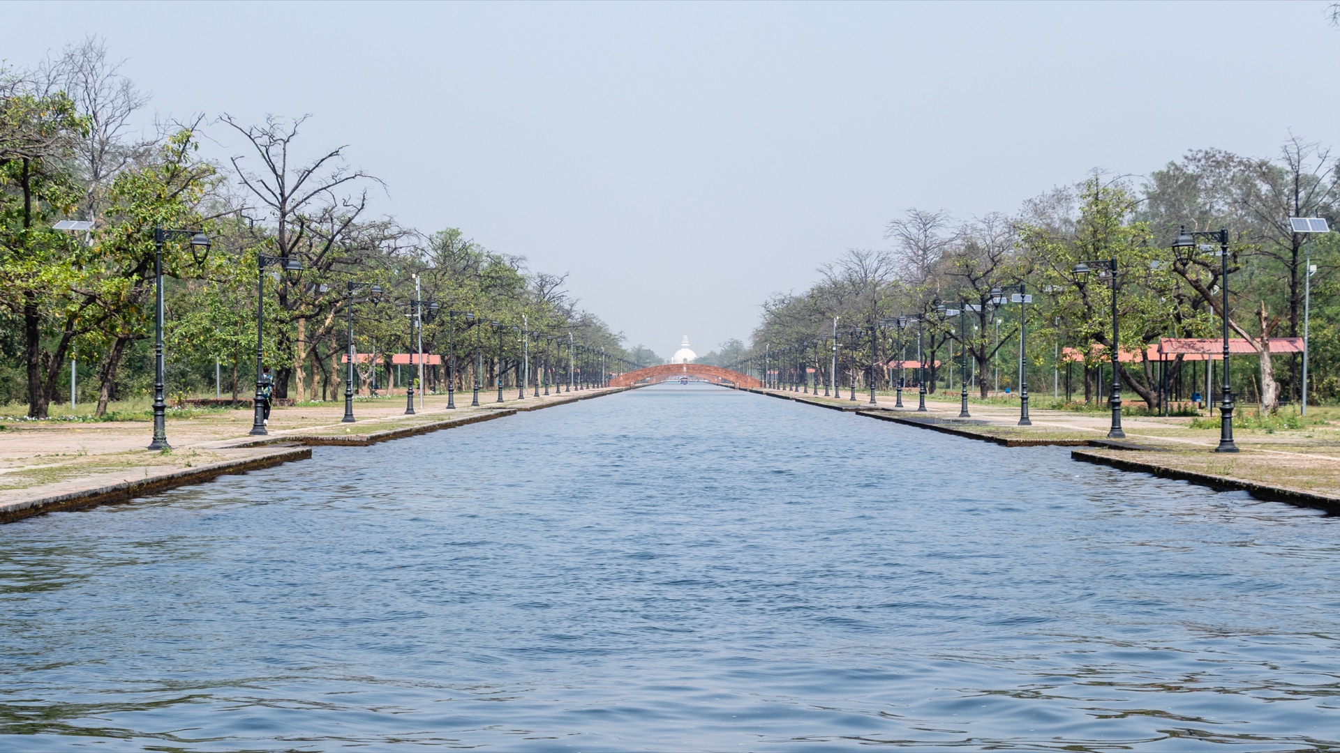 Lumbini's central canal running straight toward the World Peace Pagoda