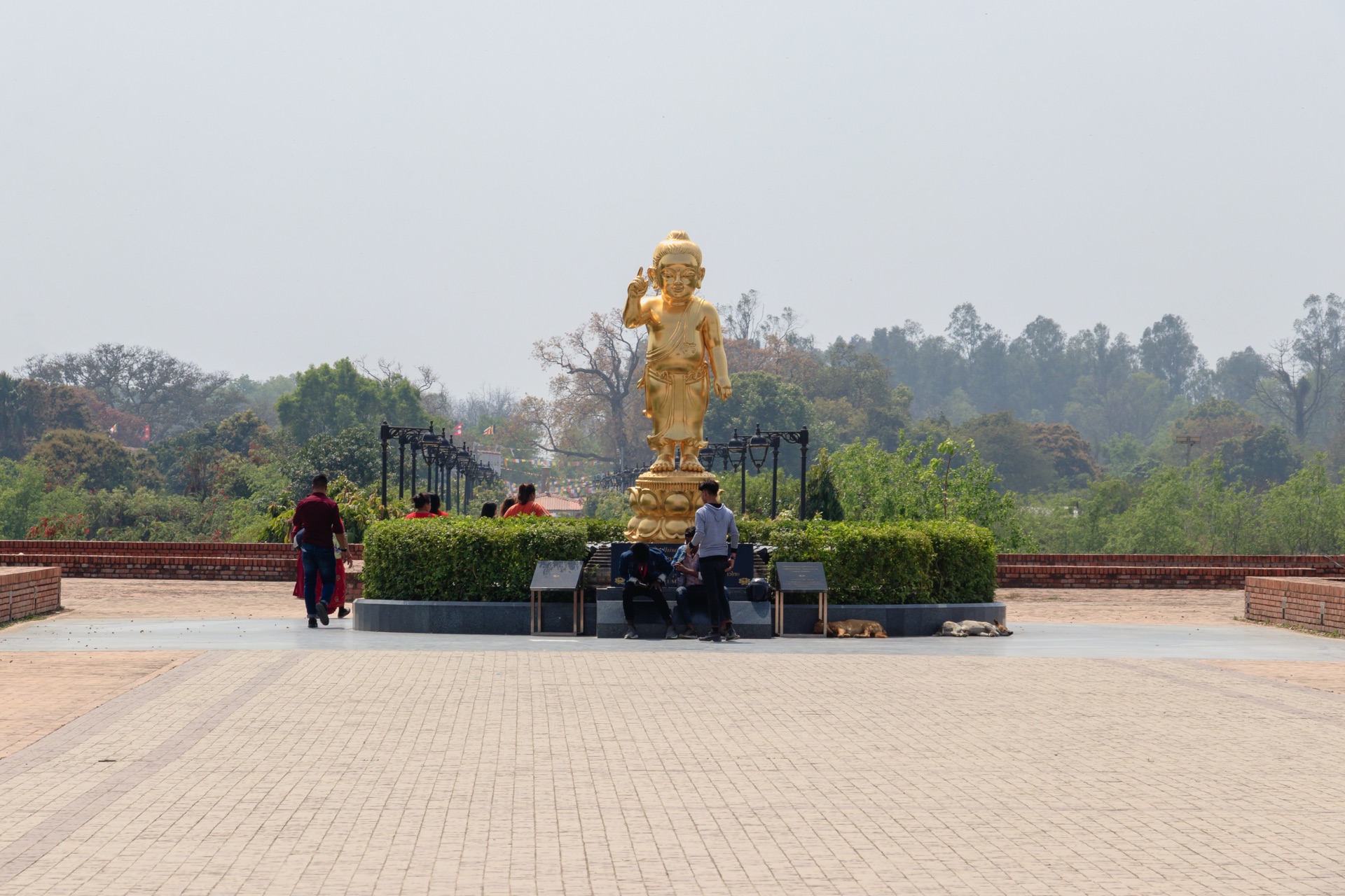 A golden statue of the infant Buddha pointing to heaven and earth