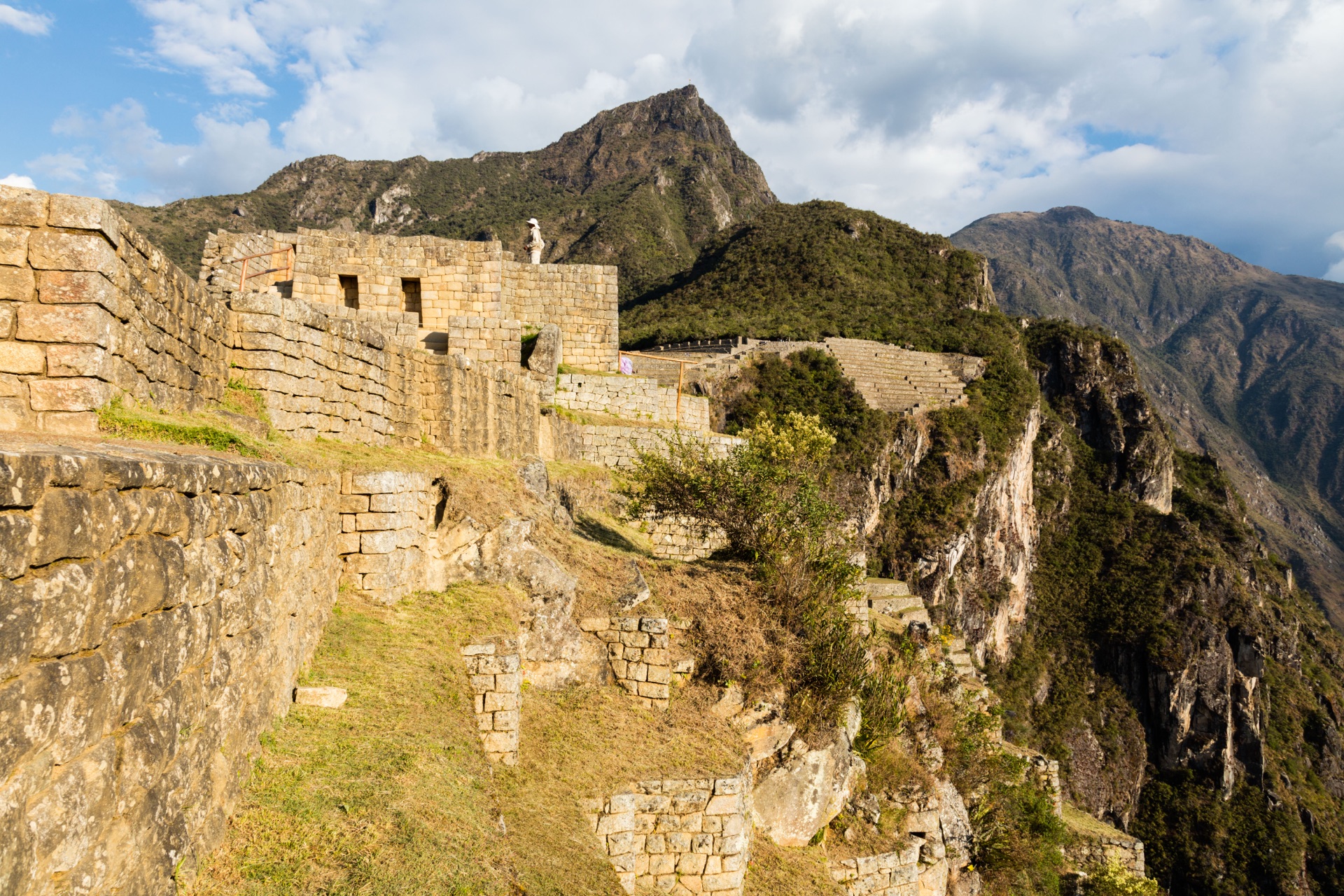 The stone terraces and halls of Machu Picchu in golden evening light