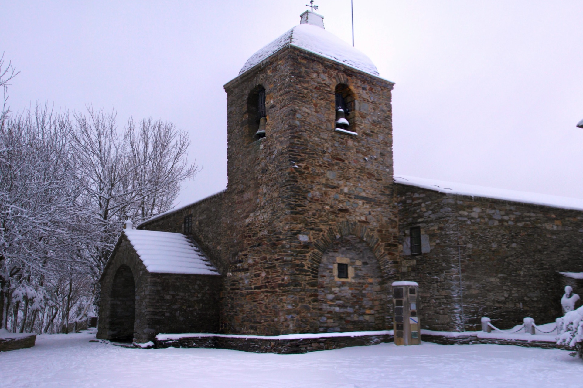 The snow-covered Church of Santa María la Real at O Cebreiro and its stone bell tower