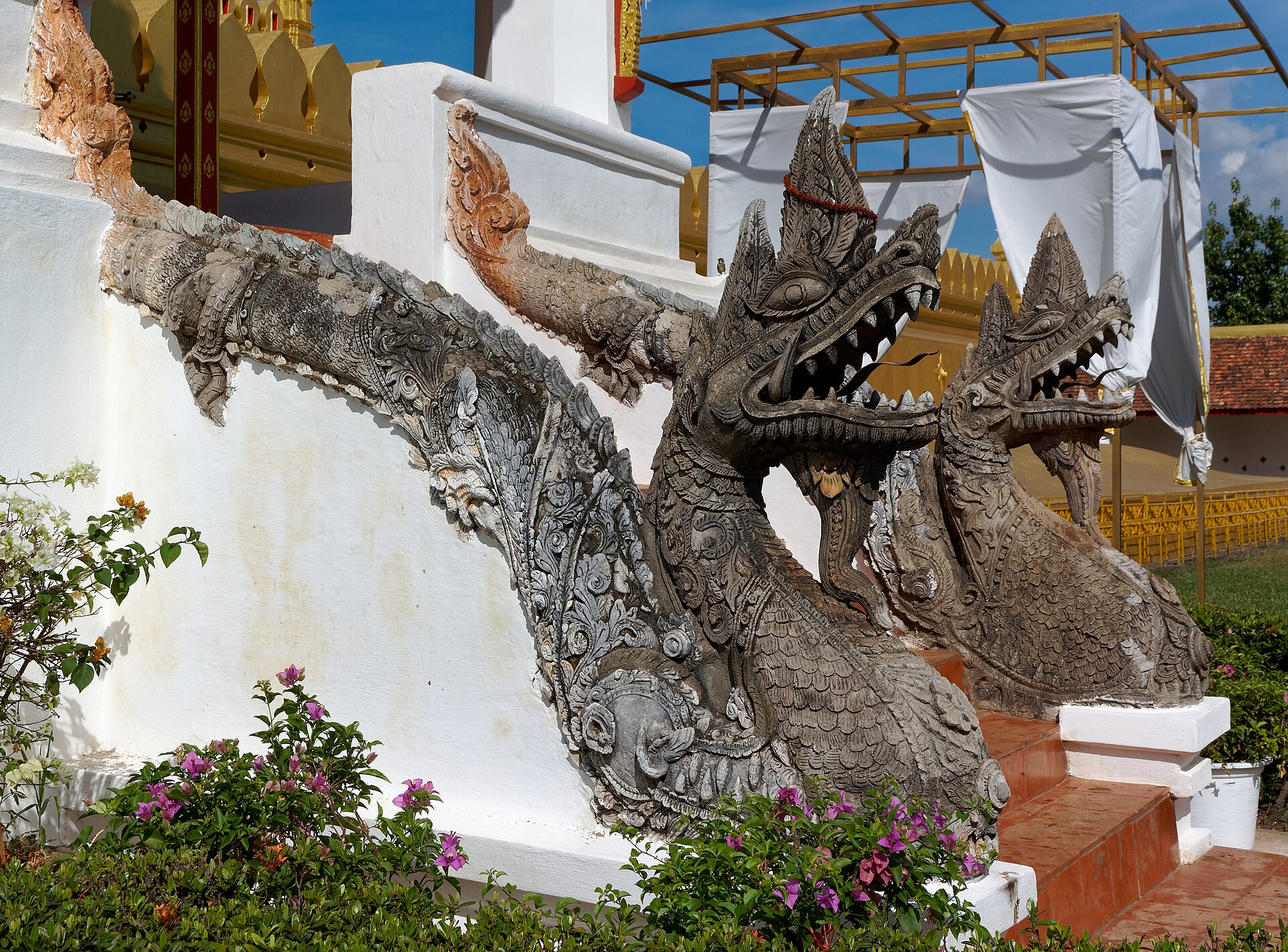A carved naga guarding the stairway of Pha That Luang