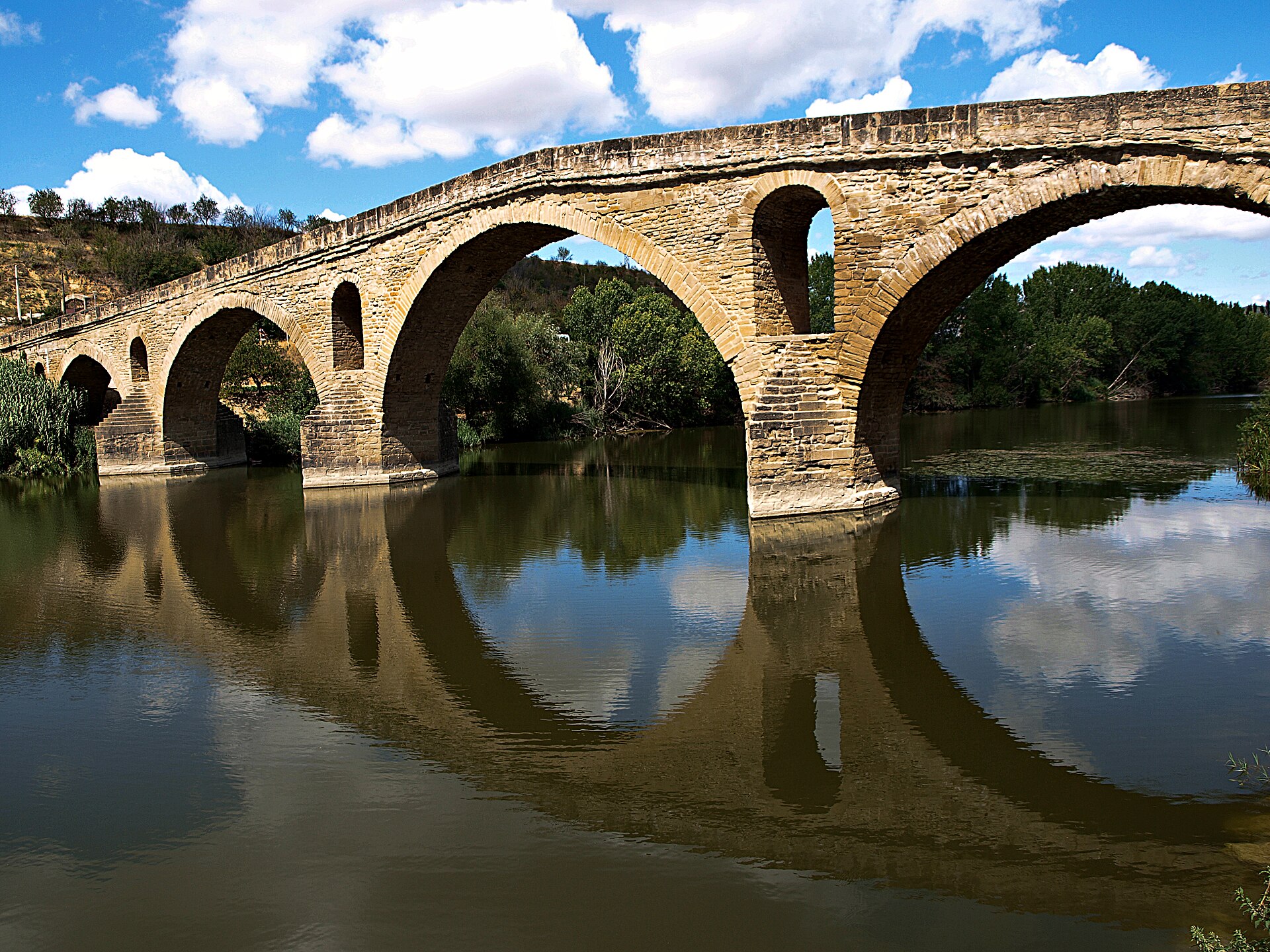 Arches of the Queen's Bridge and their reflection in the river