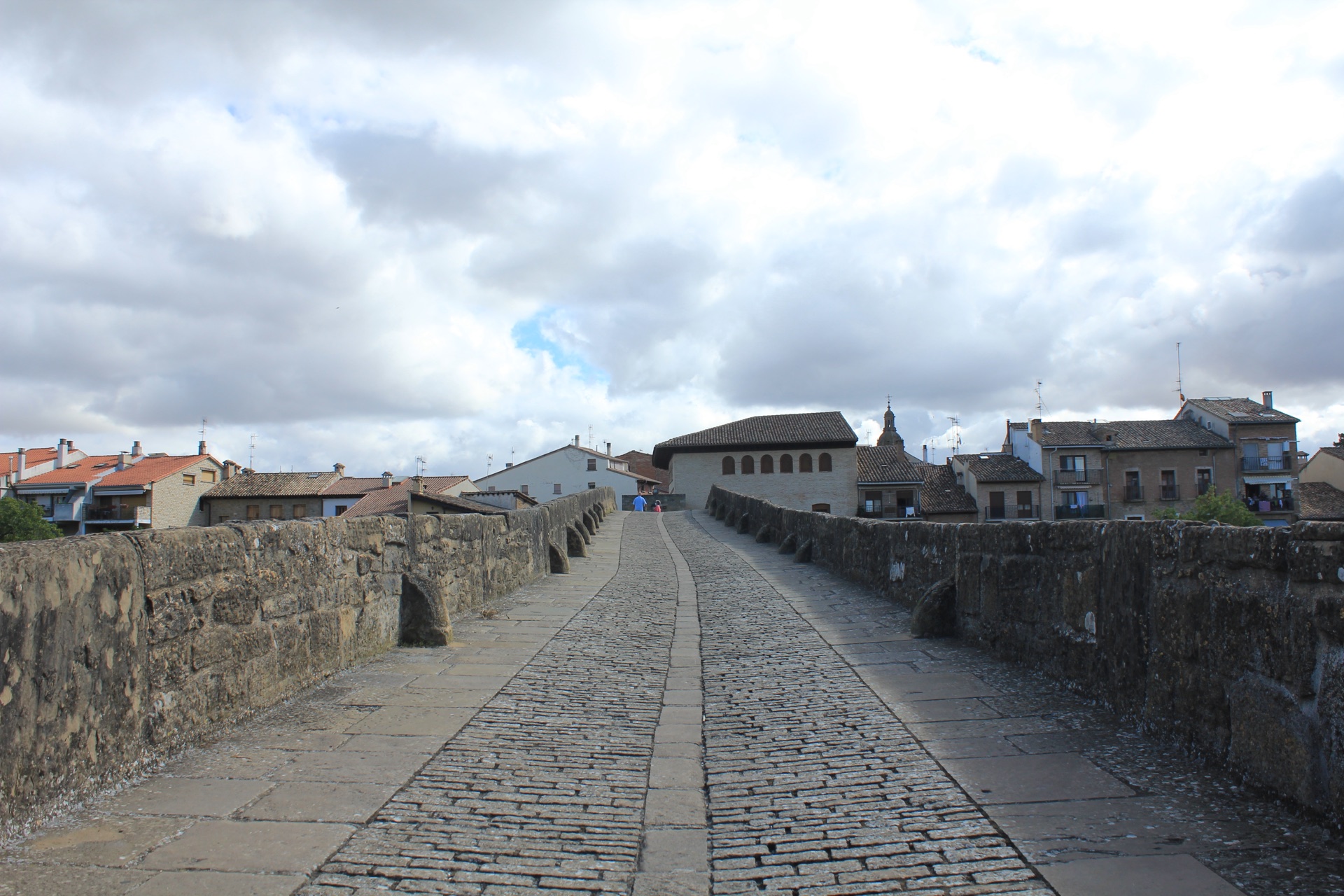 The view across the cobbled pilgrim bridge toward the town