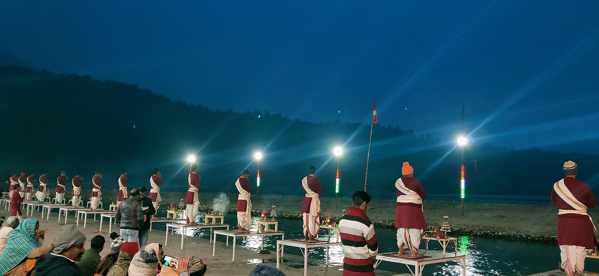 The evening Ganga Aarti — priests raising lamps in rows along the river steps