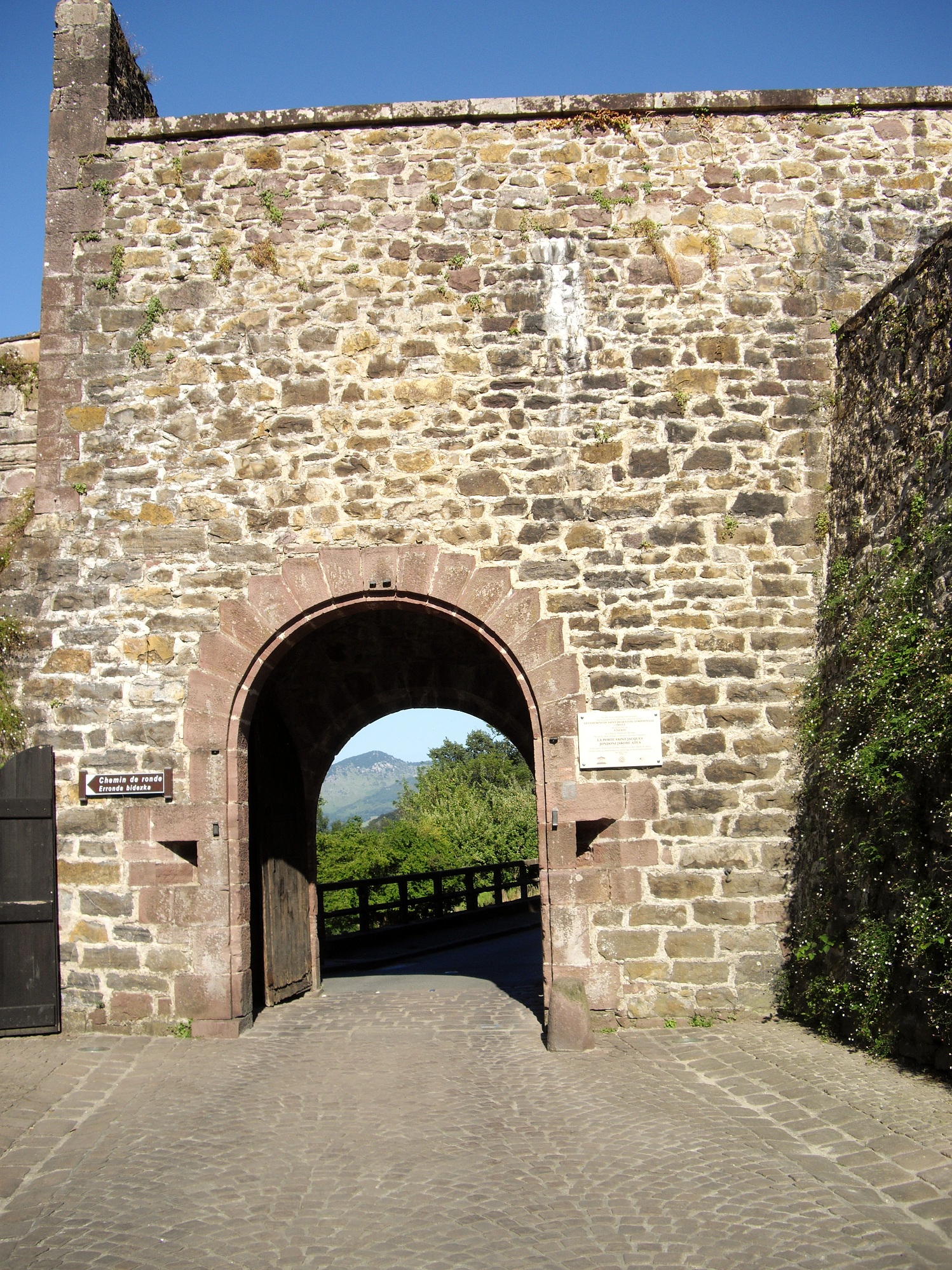 Porte Saint-Jacques, the pilgrims' gate, with the Pyrenees visible through the arch