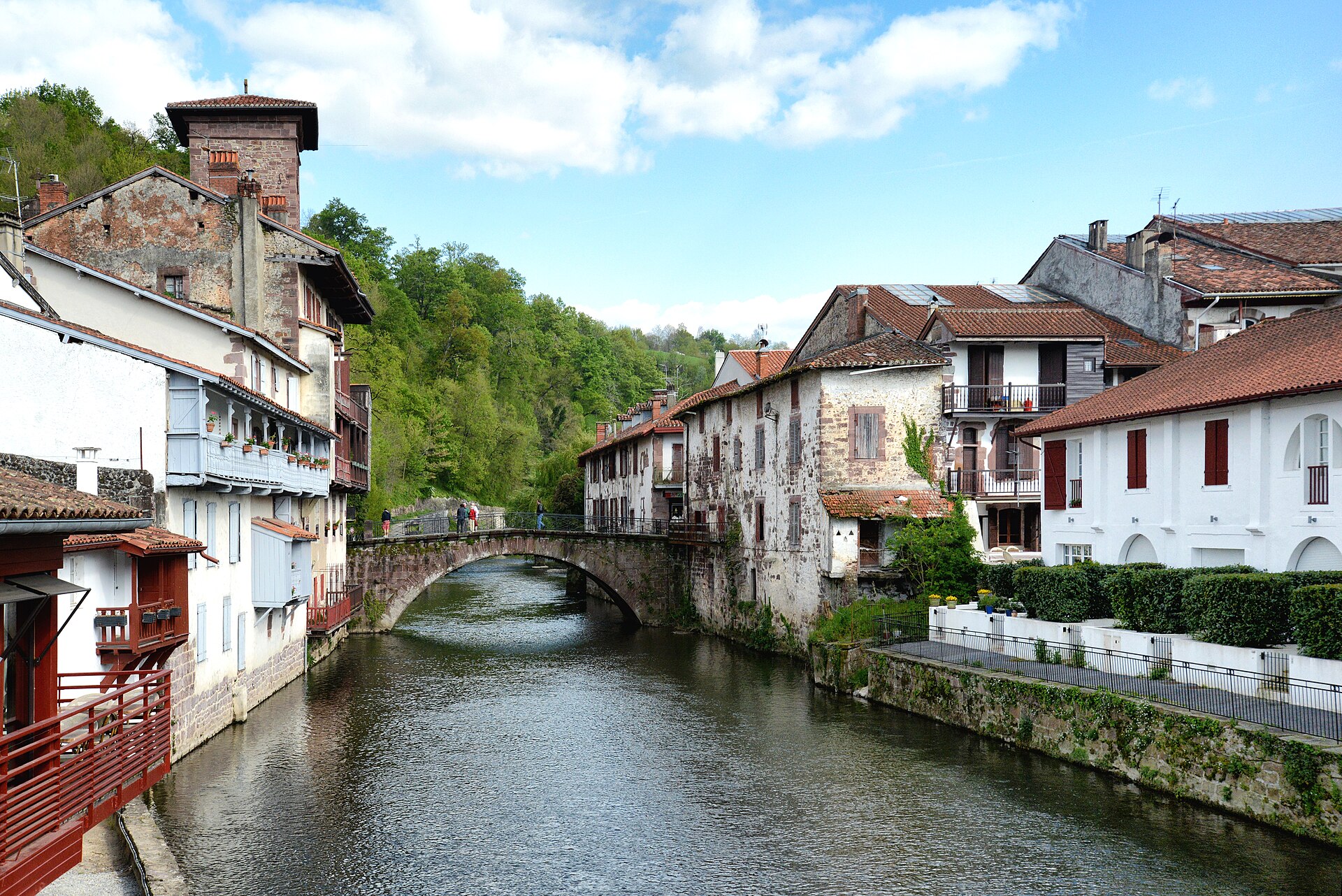 The old stone bridge over the River Nive and the Basque town mirrored in the water