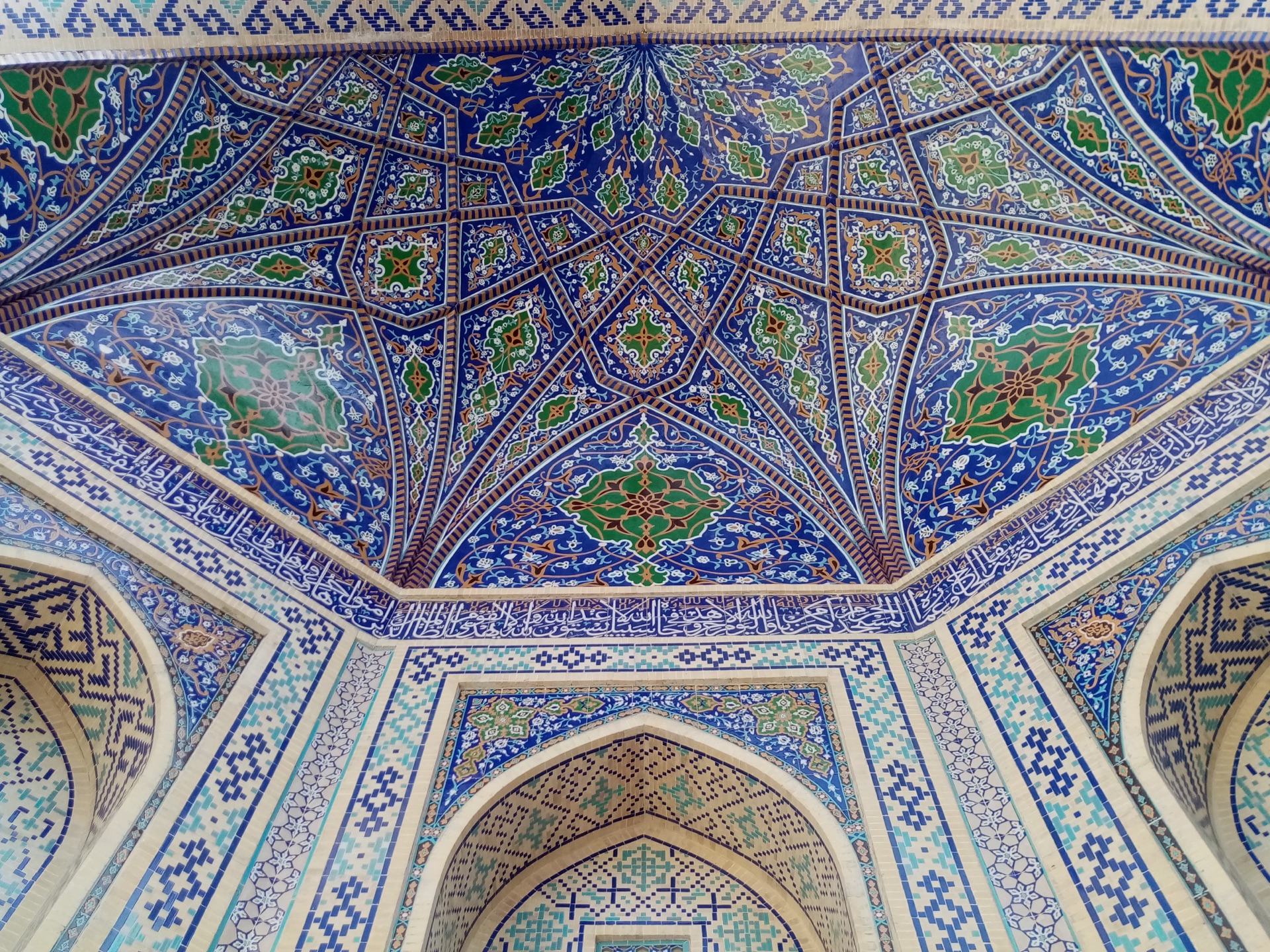The ceiling of a Registan madrasa woven with blue geometric patterns like stars