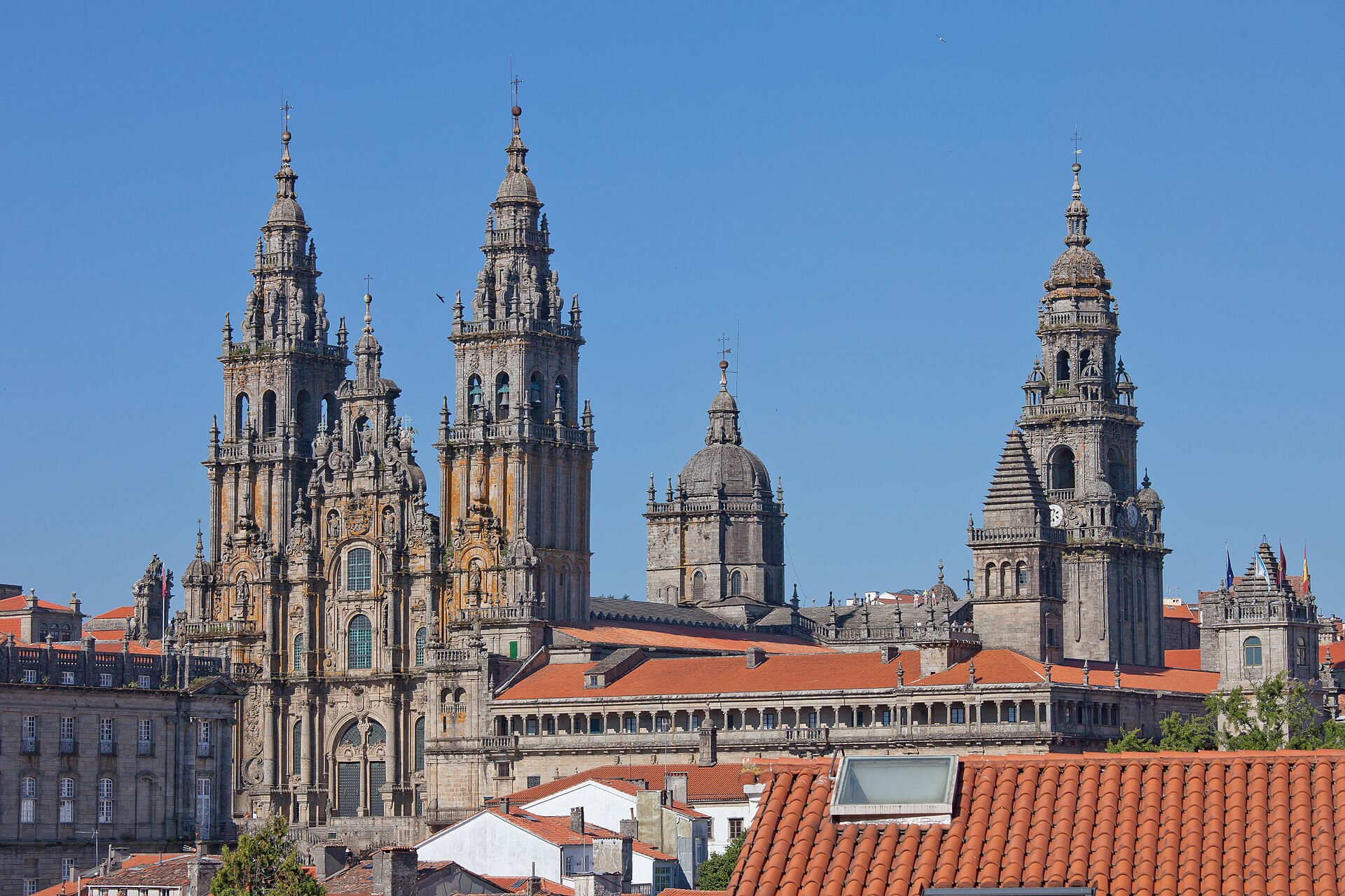 The spires of Santiago Cathedral rising above the red rooftops of the old town