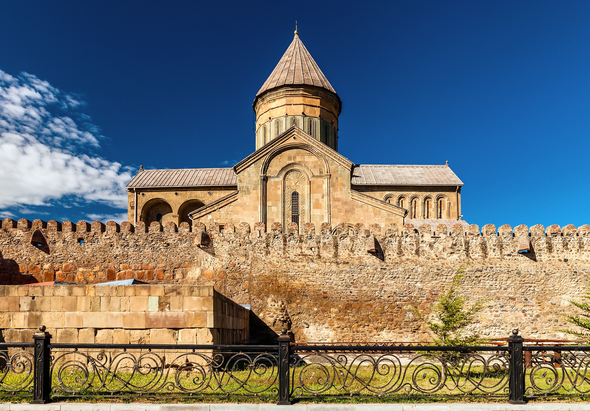 The conical roof of the cathedral rising beyond the fortress wall