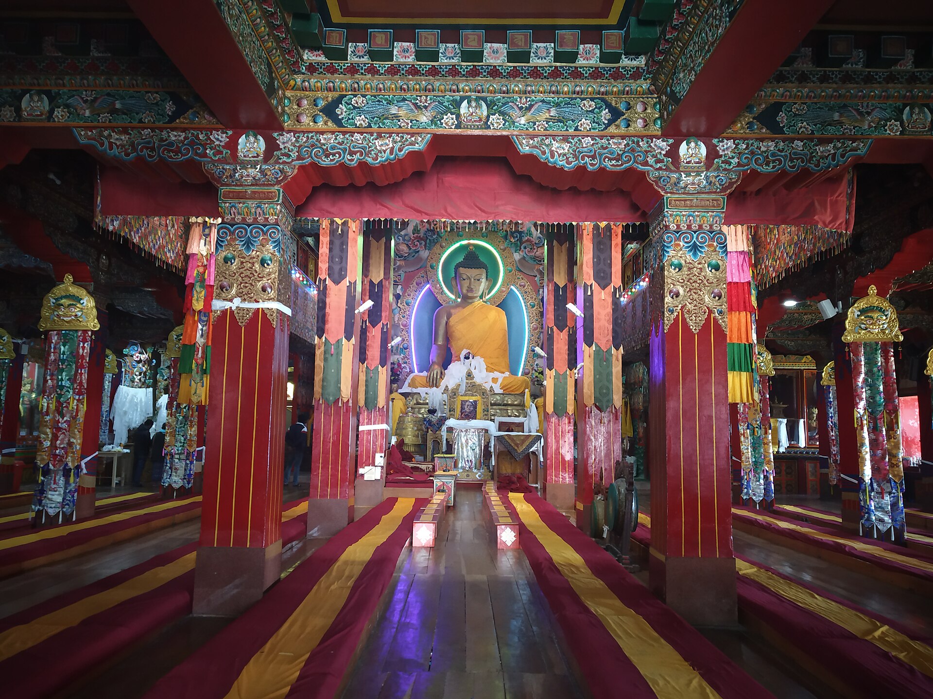 The prayer hall of Tawang Monastery lined with painted pillars and cushions