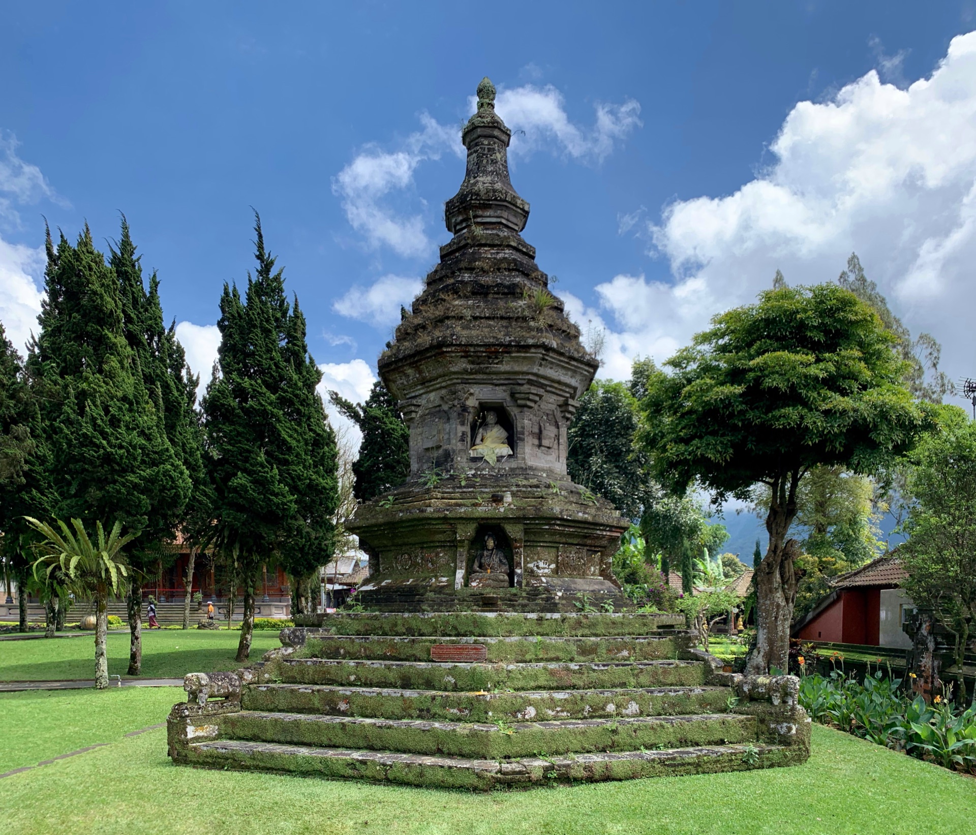 A moss-covered Buddhist stupa in the grounds of Pura Ulun Danu Bratan