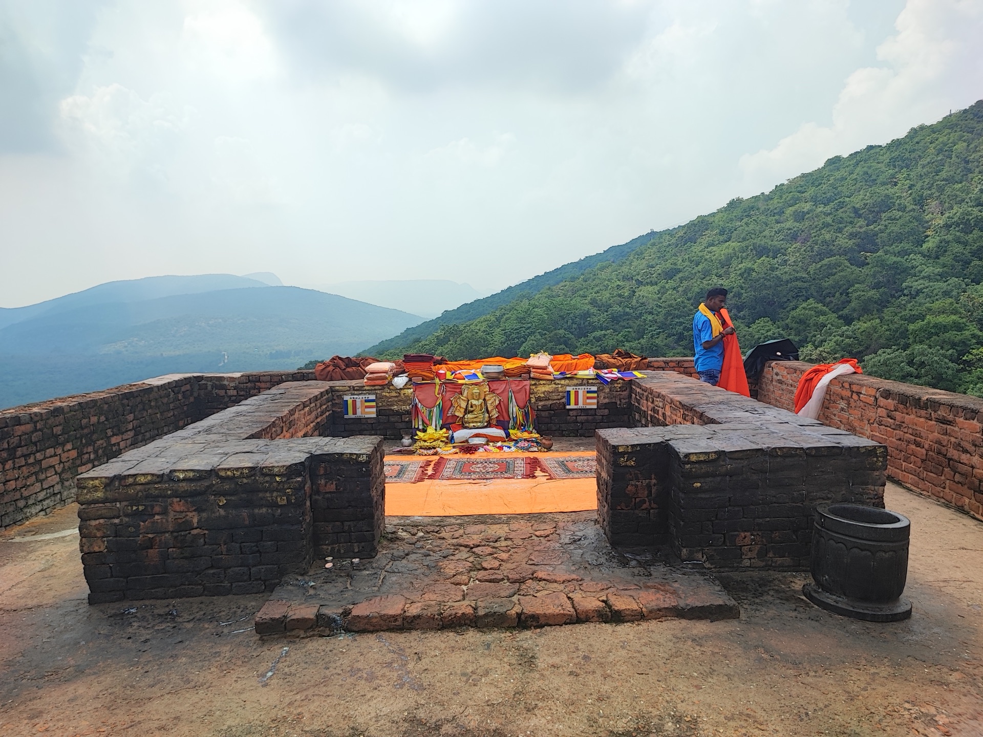Offerings laid on the summit preaching platform, a pilgrim at prayer