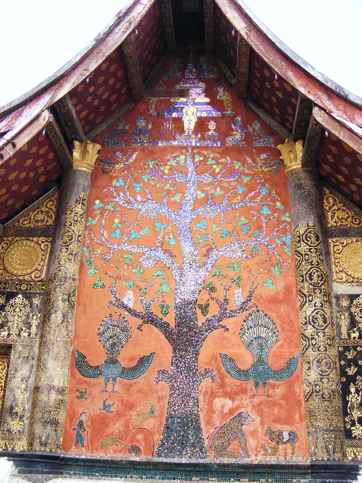 The 'tree of life' glass mosaic filling the rear wall of Wat Xieng Thong